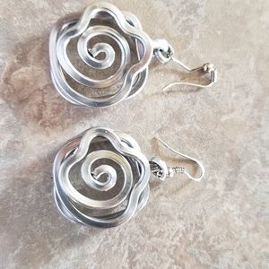 Nice silvery earrings. Cool shape. Nautilus like.